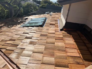 New wooden shingle roof with skylights.