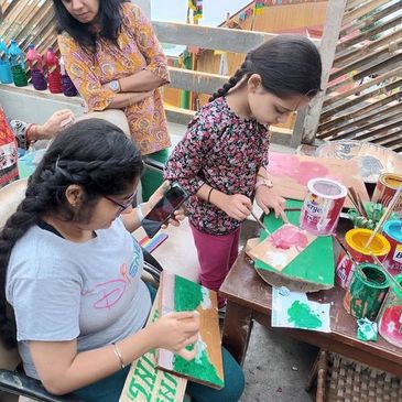 Guests engaged in Art - Paintings on wooden planks at in-house Art Studio called "Rangeela"