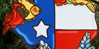 Texas-shaped decoration with birds and bluebonnets.