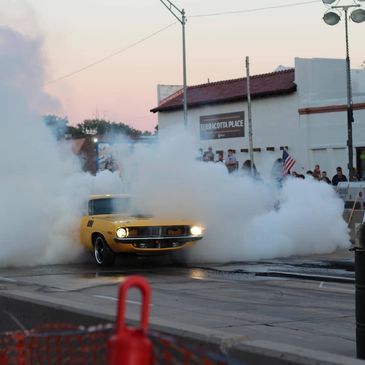 Plymouth Cuda doing burnout, tires smoking, crowd watching burnout