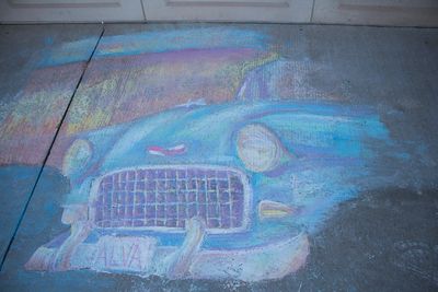 Sidewalk chalk art of a classic car