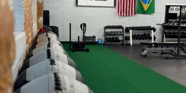 Gym interior with weights and exercise balls.