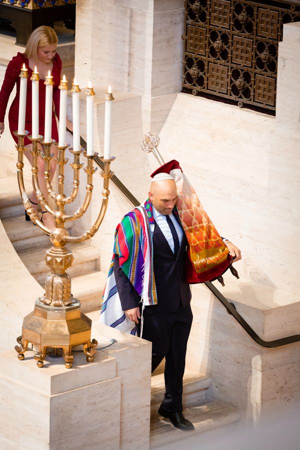 A man is carrying a dinner set on his shoulders