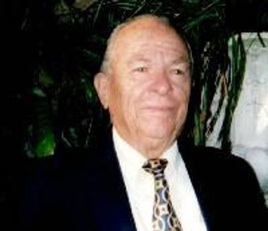 Elderly man in suit and patterned tie.