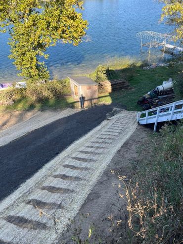 Hauled in 26 loads of fill for this hill side at Tri Lakes and added a ramp down to the lake!