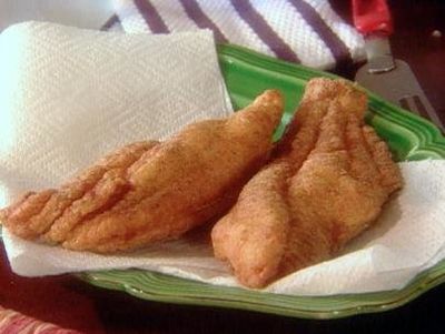 Two fried food covered on a tissue paper