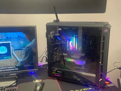 Gaming PC with RGB lighting and GeForce RTX graphics card beside a monitor.