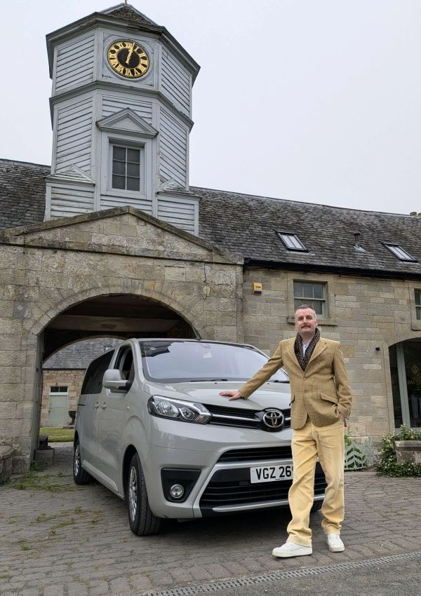 Image of host in front of transport. Also available for Transfers.