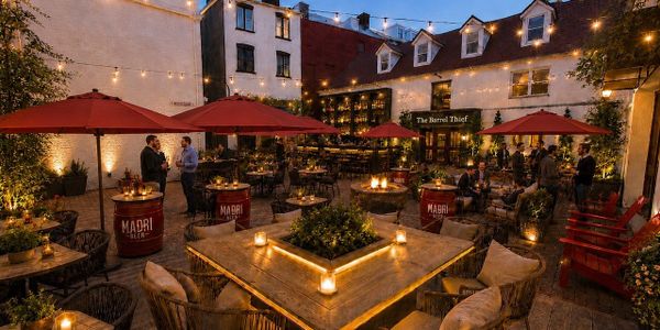 Cozy outdoor evening patio with string lights, red umbrellas, and candlelit tables.