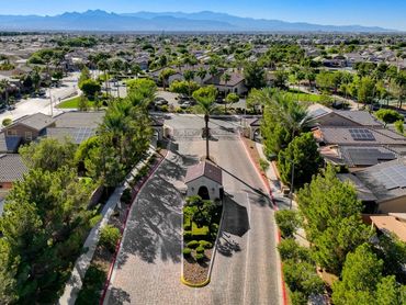 A gated suburban community with many houses and mountains in the distance.