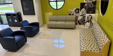 Leopard spotted sofas and two dark blue chairs