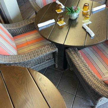 Wicker upholstered chairs around a green table