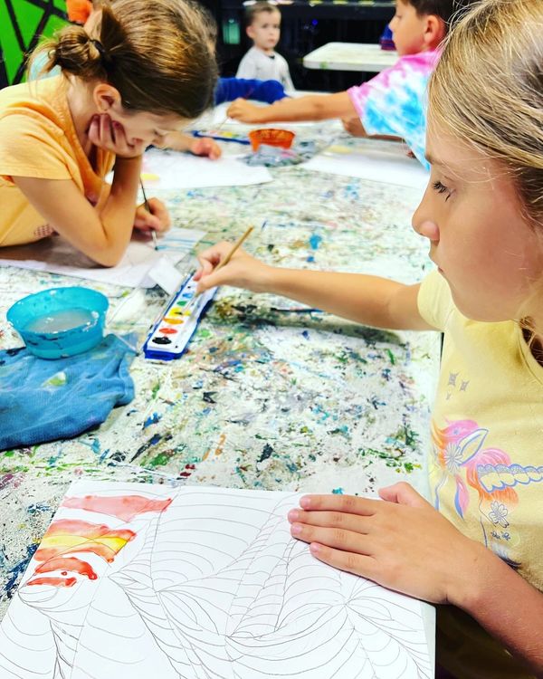 Busy child focused on creating artwork in art class