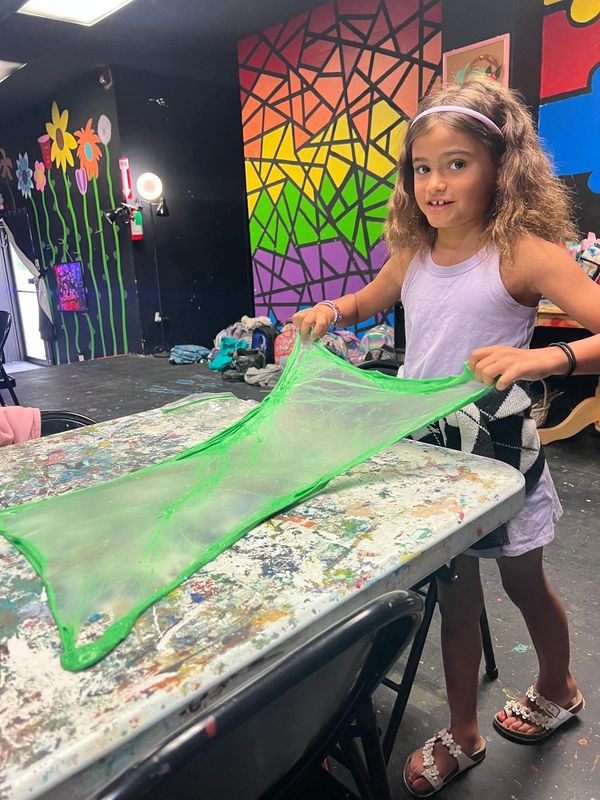 Young artists focused on their art projects in class