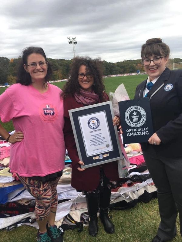 Goddess Jenn, the owner of Athena’s and the Guinness adjudicator with the world record plaque