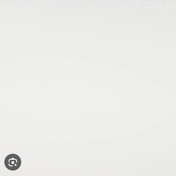 Minimalist design featuring a plain white surface.