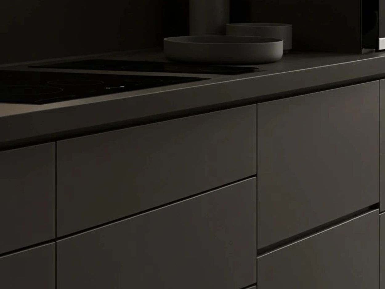 Minimalist modern kitchen with matte black cabinetry and countertop.