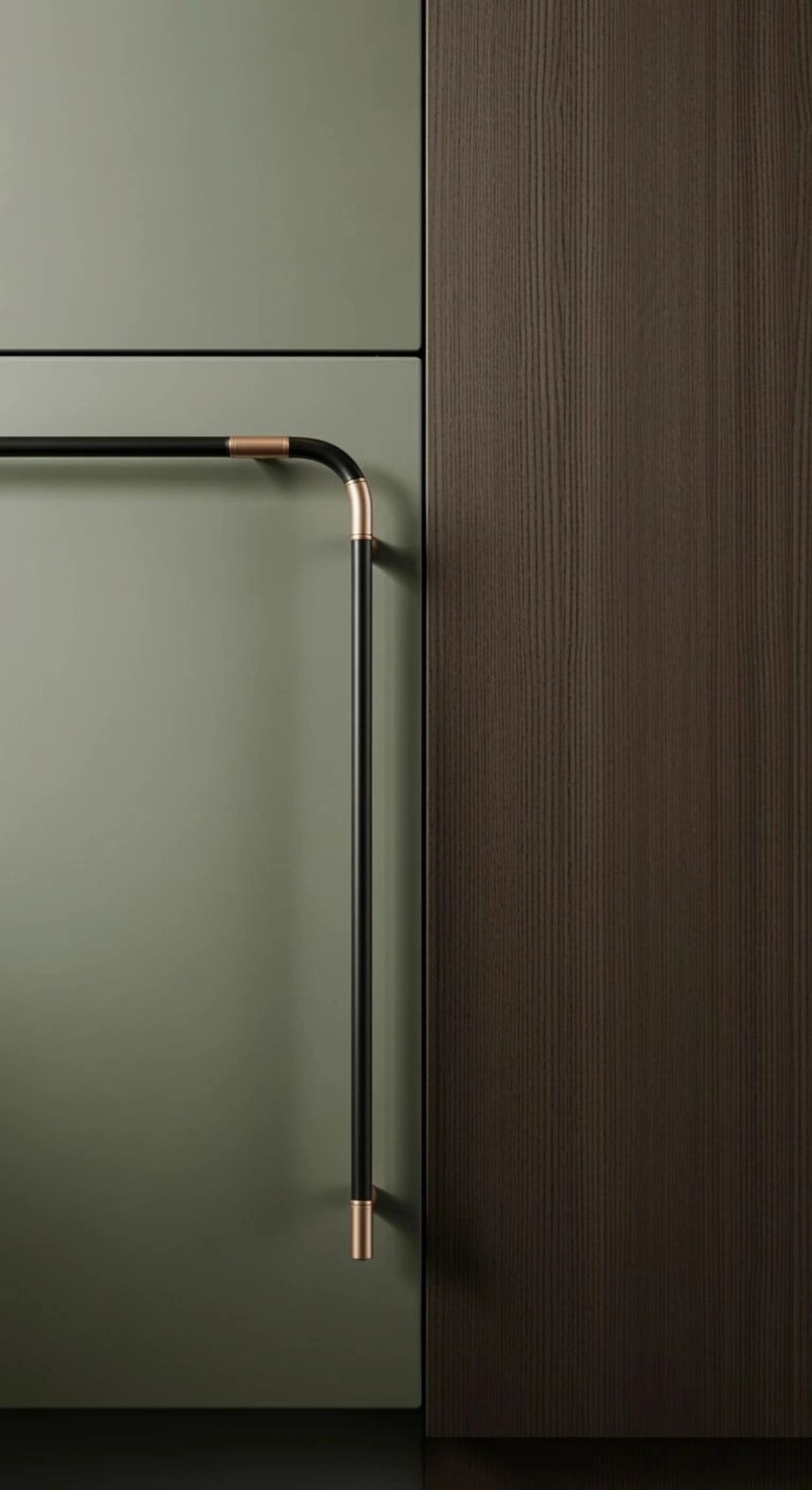 Close-up of a modern cabinet handle with black and copper accents on green and brown panels.