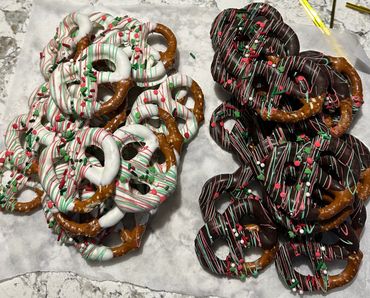 Holiday pretzels dipped in white and dark chocolate with festive sprinkles.