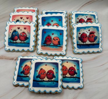 Decorated cookies featuring colorful cartoon lovebirds with heart motifs.