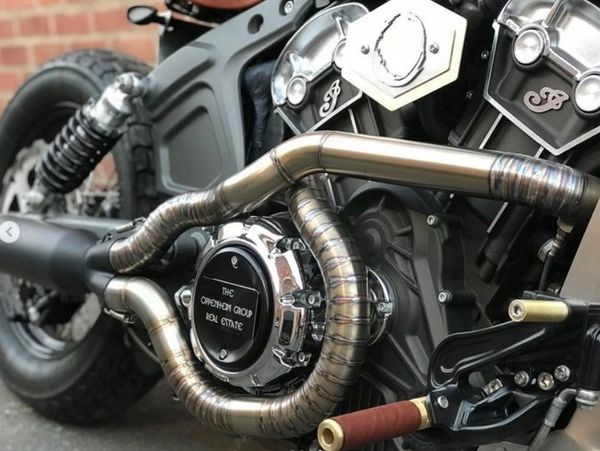 Close-up of a custom motorcycle engine with intricate exhaust pipes.