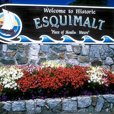 Welcome sign for Historic Esquimalt with colorful flowers.