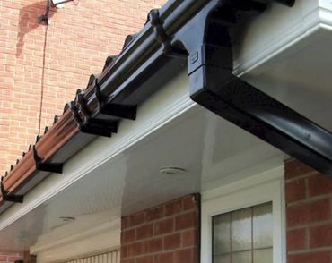 White upvc Facsia’s & Soffits with black guttering & down pipes