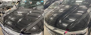 Two black car hoods with markings and reflections in an indoor parking area.