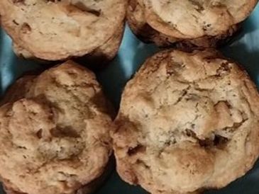 Close-up of four homemade cookies on a blue plate.