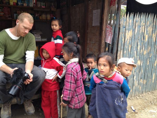 Greg, our photographer and team member is showing the local kids his camera.