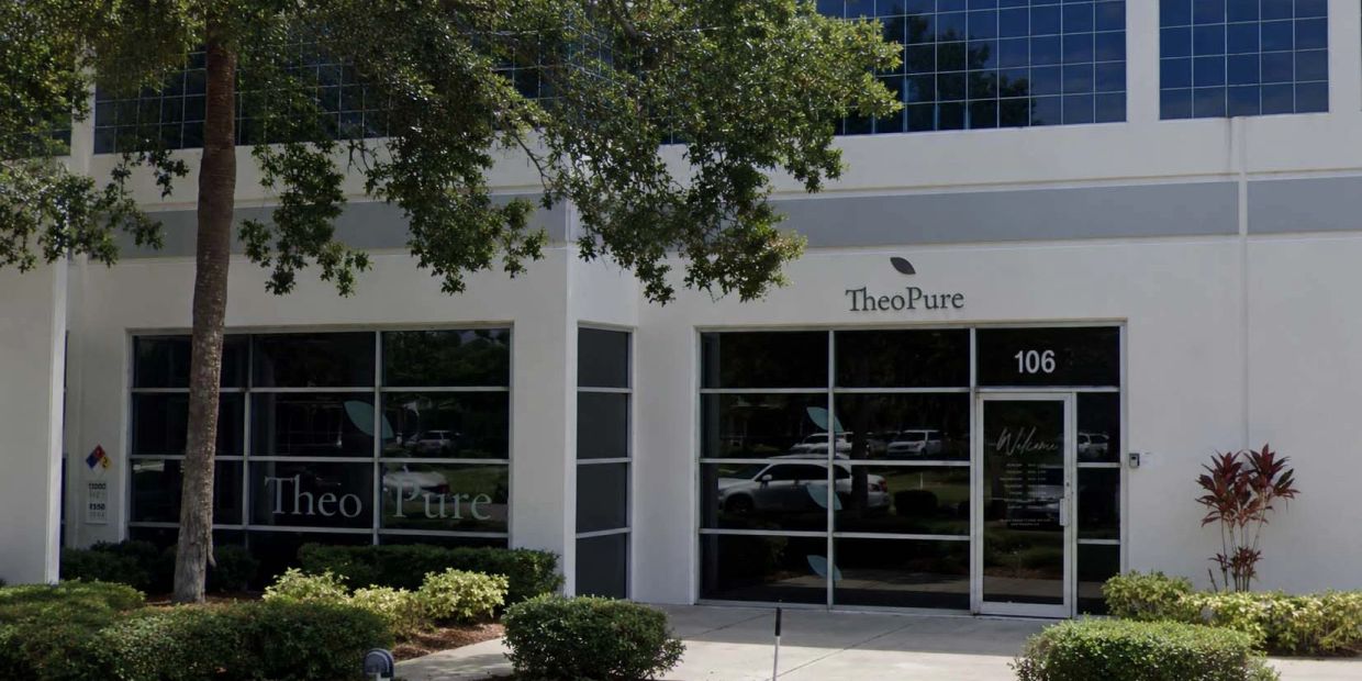 Exterior of a modern office building with the name TheoPure.