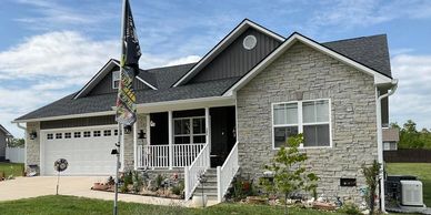 A modern suburban house with stone facade and a garage.