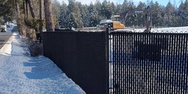 Chin-link fence with black slats and gate
