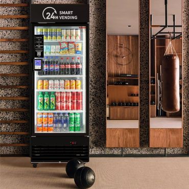 A smart vending machine stocked with drinks and snacks in a modern gym.