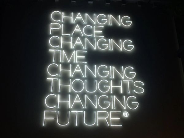 Neon sign with words about change and future.