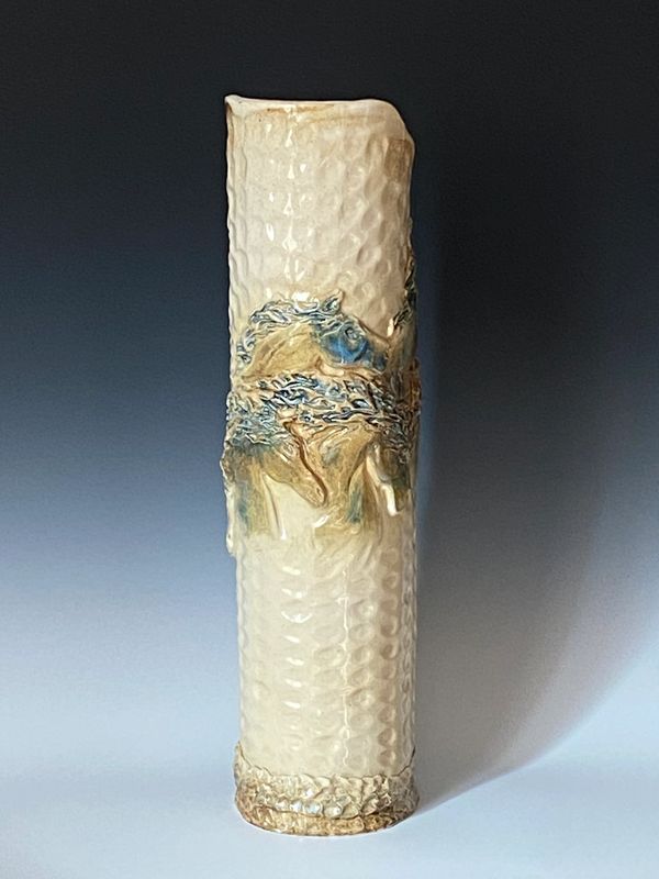 Tall ceramic vase with running horses in blues and cream colors by Ceramic Artist Christine Bravata.