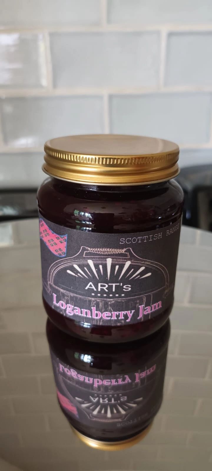 Jar of Art's Loganberry Jam from Scottish range with gold lid.
