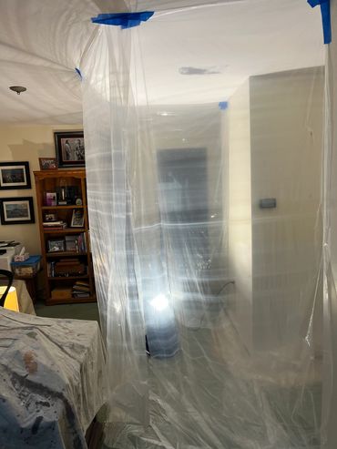 Plastic sheeting covering a large section of an indoor space.