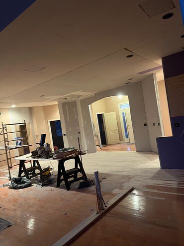 Interior of a house under construction with tools and scaffolding.