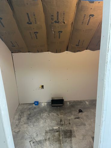 Unfinished room with drywall and insulation.