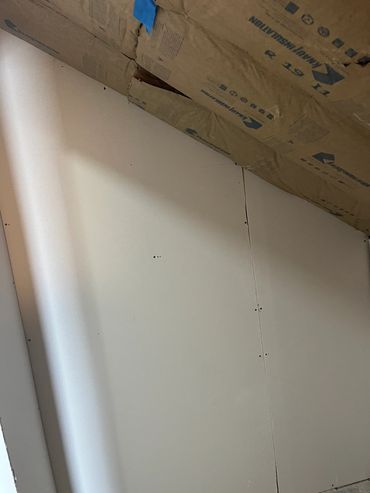 Ceiling insulation with cardboard covering.