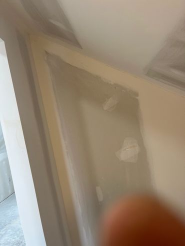 Wall patching and drywall repair in progress.
