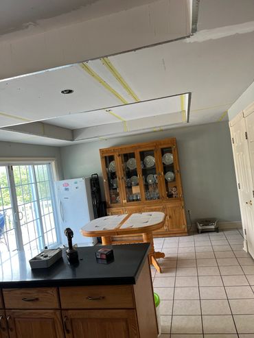 Kitchen with renovation work on the ceiling underway.