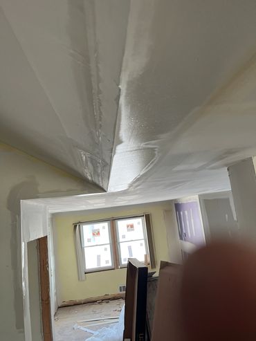 Ceiling with water damage and bubbles during renovation.