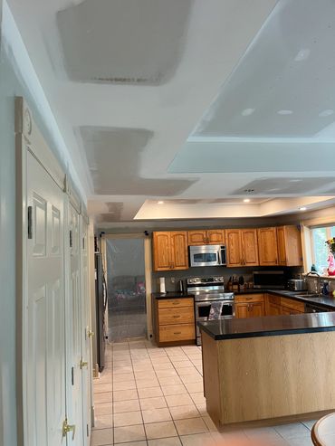Kitchen undergoing ceiling drywall repair.