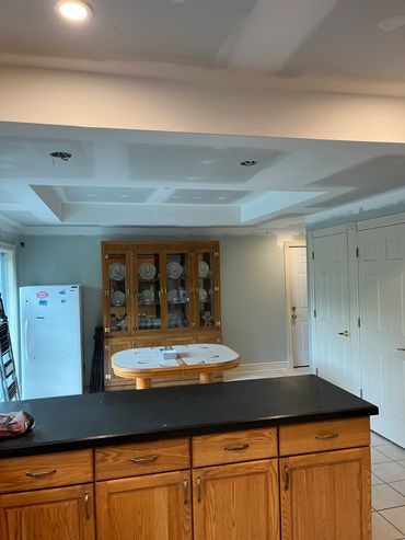 Kitchen ceiling undergoing renovation with recessed lighting.