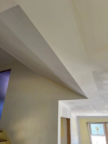 Interior home under construction with unfinished drywall.