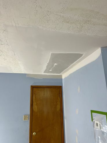 Ceiling undergoing patching and painting work.