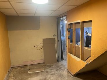 Room under renovation with exposed studs and unfinished walls.