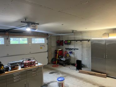 Clean and organized garage with tools and storage.